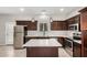 Modern kitchen boasting stainless steel appliances, an island, and dark wood cabinets at 2000 N 36Th St # 30, Phoenix, AZ 85008