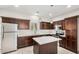 Well-lit kitchen features stainless steel appliances, an island, and dark wood cabinetry at 2000 N 36Th St # 30, Phoenix, AZ 85008