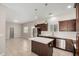 Open kitchen with dark cabinets, stainless appliances and kitchen island at 2000 N 36Th St # 30, Phoenix, AZ 85008