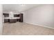 Open-concept kitchen area with stainless appliances, dark cabinetry and tile floors at 2000 N 36Th St # 30, Phoenix, AZ 85008