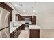 A close-up of the kitchen features stainless appliances, stone countertops and dark cabinets at 2000 N 36Th St # 30, Phoenix, AZ 85008