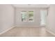 Bright living room featuring neutral paint, tile flooring, and natural light from the large windows at 2000 N 36Th St # 30, Phoenix, AZ 85008