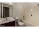 Well-lit bathroom featuring a shower-tub combo, toilet, and vanity with a sink and a mirror at 23682 W Bowker St, Buckeye, AZ 85326