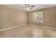 Spacious bedroom featuring neutral walls, ceiling fan, window, and tile flooring at 23682 W Bowker St, Buckeye, AZ 85326