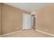 Bedroom with neutral walls, tile floors and closet doors at 23682 W Bowker St, Buckeye, AZ 85326
