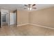 Bedroom with tile floors, ceiling fan, and entry to other rooms at 23682 W Bowker St, Buckeye, AZ 85326