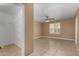 Bedroom featuring a ceiling fan, closet, tile floors, and natural light from a window at 23682 W Bowker St, Buckeye, AZ 85326