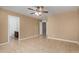 Bedroom with neutral walls, tile floors, and entry to a bathroom at 23682 W Bowker St, Buckeye, AZ 85326
