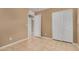 Bedroom with tile floors and white closet and bathroom doors at 23682 W Bowker St, Buckeye, AZ 85326