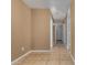 Long hallway with tile flooring and several doorways, offering access to various rooms at 23682 W Bowker St, Buckeye, AZ 85326