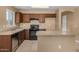View of kitchen featuring tile floors, stainless appliances, and a center island for cooking at 23682 W Bowker St, Buckeye, AZ 85326