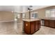 Open concept kitchen with granite island, stainless steel appliances, and tile flooring at 23682 W Bowker St, Buckeye, AZ 85326