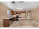 Traditional kitchen featuring wood cabinets, tile flooring, and a center island with a light countertop at 23682 W Bowker St, Buckeye, AZ 85326