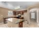 Functional kitchen featuring an island with light countertops and dark wood cabinets at 23682 W Bowker St, Buckeye, AZ 85326