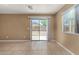 Bright living room with tile flooring, sliding door access to the backyard and a window with blinds at 23682 W Bowker St, Buckeye, AZ 85326