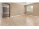 Spacious living room with neutral walls, tile flooring, and a view leading to other rooms at 23682 W Bowker St, Buckeye, AZ 85326