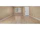 Light-filled living area featuring tile flooring, a white front door, and ample natural light at 23682 W Bowker St, Buckeye, AZ 85326