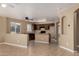 Open layout connecting the living room to the kitchen featuring neutral walls and tiled floors at 23682 W Bowker St, Buckeye, AZ 85326