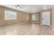 Bright, airy living room with neutral walls, tile floors, and two large windows at 23682 W Bowker St, Buckeye, AZ 85326