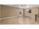Spacious living room with tiled flooring and sliding door access to the backyard at 23682 W Bowker St, Buckeye, AZ 85326