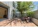 Relaxing backyard with brick patio, leafy tree, and cozy seating area, offering an inviting outdoor retreat at 240 W Missouri Ave # 1, Phoenix, AZ 85013
