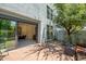 Charming backyard featuring a brick patio, lush greenery, and an open view into the kitchen, perfect for relaxing at 240 W Missouri Ave # 1, Phoenix, AZ 85013