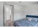 Bright bedroom with carpet flooring, a comfortable blue bed, and a sliding door closet for convenient storage at 240 W Missouri Ave # 1, Phoenix, AZ 85013