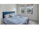 Cozy bedroom with a comfortable blue bed and plenty of natural light streaming through the large windows at 240 W Missouri Ave # 1, Phoenix, AZ 85013