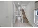 Bright hallway with neutral tile flooring and access to the upper level at 240 W Missouri Ave # 1, Phoenix, AZ 85013