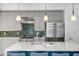 Modern kitchen features an island with barstool seating, stainless steel appliances, and plenty of counter space at 240 W Missouri Ave # 1, Phoenix, AZ 85013