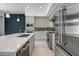 Modern kitchen design features stainless steel appliances and an island with seating, plus views to the living area at 240 W Missouri Ave # 1, Phoenix, AZ 85013