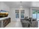 Bright living room with contemporary lighting, stylish gray couch, and desert-themed art at 240 W Missouri Ave # 1, Phoenix, AZ 85013