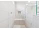This bathroom features a large, tiled shower with a built-in bench and sleek, modern fixtures at 25876 N 162Nd Dr, Surprise, AZ 85387