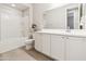 This bright bathroom includes a modern vanity with ample storage space and stylish fixtures at 25876 N 162Nd Dr, Surprise, AZ 85387