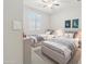 Charming bedroom with twin beds, neutral decor, and plenty of natural light from the window at 25876 N 162Nd Dr, Surprise, AZ 85387