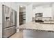 Modern kitchen featuring stainless steel appliances, granite countertops, and ample storage space in the pantry at 25876 N 162Nd Dr, Surprise, AZ 85387