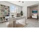 This home office features a large window, built-in shelving, and a modern desk at 25876 N 162Nd Dr, Surprise, AZ 85387