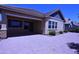 Paver patio leads to the backyard with mature landscaping, a brick privacy wall, and blue sky above at 2811 S Jeffry St, Gilbert, AZ 85295