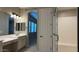 Bright bathroom featuring double vanity sinks, framed mirror and large glass shower with seat at 2811 S Jeffry St, Gilbert, AZ 85295