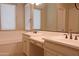 Bright bathroom featuring dual sinks, custom cabinetry, and tile floors with natural light at 2811 S Jeffry St, Gilbert, AZ 85295