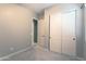 Bedroom with neutral carpet, base molding, and standard closet with sliding doors at 2811 S Jeffry St, Gilbert, AZ 85295