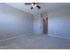 Bright bedroom with neutral carpet, base molding, standard closet, and ceiling fan at 2811 S Jeffry St, Gilbert, AZ 85295