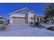 Charming single-story home features a tan exterior, brick driveway, attached garage, and manicured landscaping at 2811 S Jeffry St, Gilbert, AZ 85295