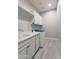 Bright laundry room features wood-look tile floors, white cabinetry, sink, and modern washing machine at 2811 S Jeffry St, Gilbert, AZ 85295