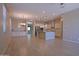 Open-concept living space featuring wood-look tile floors, recessed lighting, and a kitchen with white cabinets at 2811 S Jeffry St, Gilbert, AZ 85295