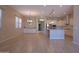 Open-concept living space featuring a kitchen with white cabinets, granite countertops, and a dining area at 2811 S Jeffry St, Gilbert, AZ 85295