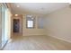 Neutral living space featuring wood-look tile flooring and a view to another room via a large archway at 2811 S Jeffry St, Gilbert, AZ 85295