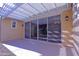 Covered patio features a white pergola, neutral flooring, and sliding glass doors to the home's interior at 2811 S Jeffry St, Gilbert, AZ 85295