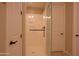 Bathroom with a glass enclosed shower, tiled flooring, and a brushed metal shower head at 2811 S Jeffry St, Gilbert, AZ 85295