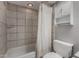 Tiled bathroom with a shower and bath combination featuring a shower curtain and a small vanity at 3705 W Villa Theresa Dr, Glendale, AZ 85308